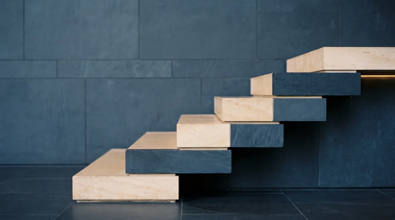 Precisely cut limestone and navy stone blocks rising in steps against a navy wall
